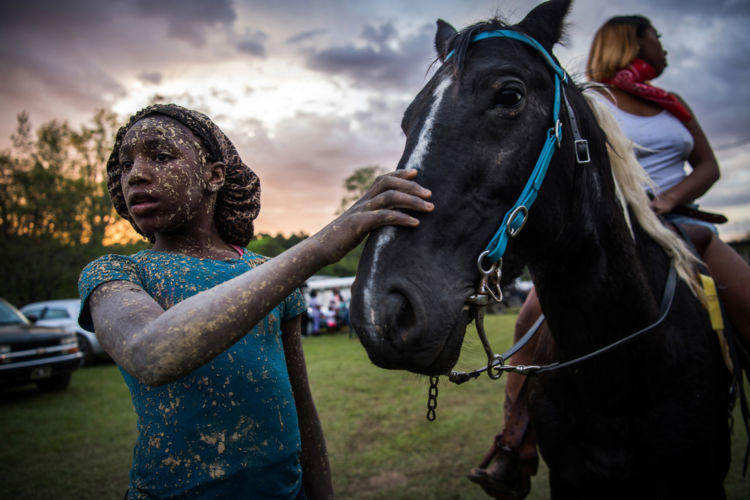Bree Gary pets her friend’s horse during a muddy trail ride in Charleston, Mississippi April 27, 2019.